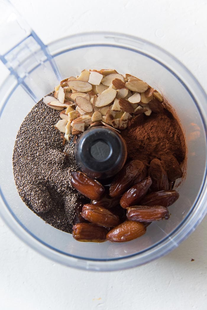 All the ingredients in the food processor bowl to make the chocolate chia bliss balls. 