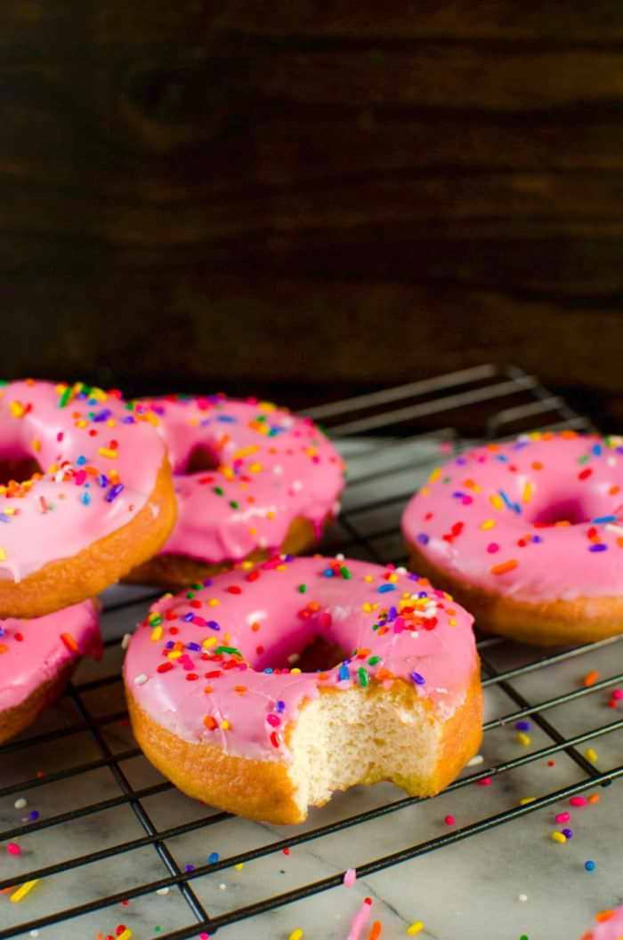 The Simpsons Doughnuts - These pink glazed doughnuts with sprinkles is Homer Simpsons favorite snack!  and now you can make them at home with a FULL TUTORIAL to make perfect doughnuts everytime!