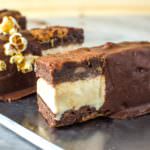 Peanut Butter Swirled Chocolate Brownie Ice Cream sandwiches, made with Kettle Corn Ice Cream (salted caramel popcorn ice cream). Homemade popcorn flavoured ice cream sandwiched between fudgy PB chocolate brownies that tastes like reese’s peanut butter cups! Make it with store bought ice cream, and dip it in Chocolate magic shell for added decadence.