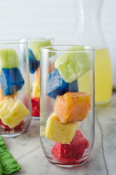 Rainbow Ice Cubes - Make your drinks like your favourite lemonade, fun with these Rainbow Ice Cubes all made with natural colours and flavours to add more fruityness to your rainbow lemonade! 