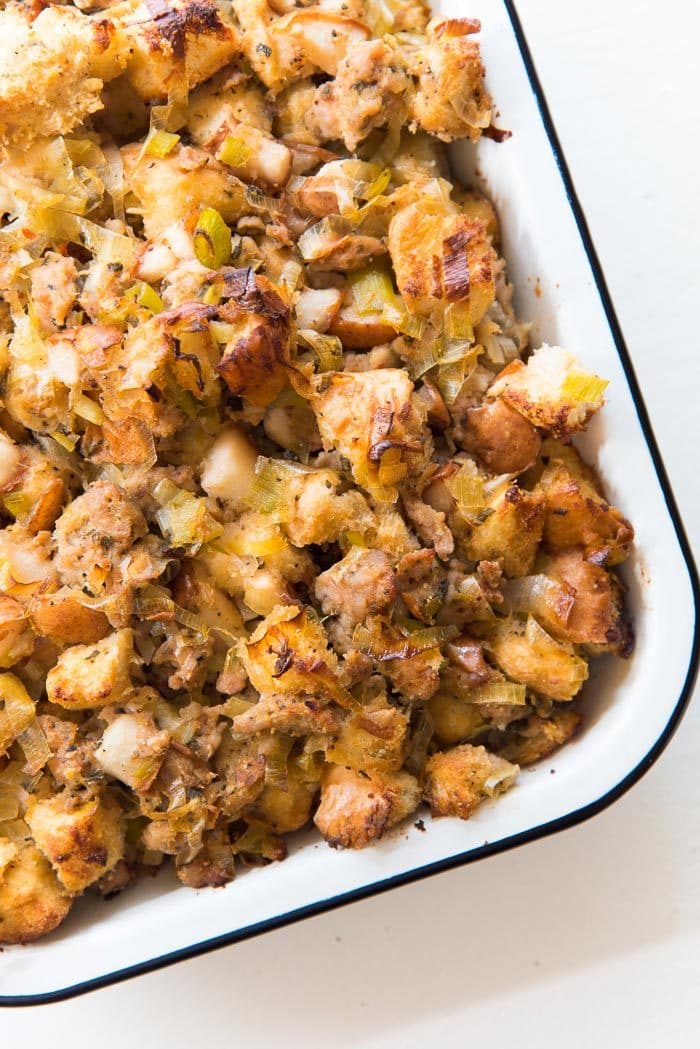 Sage Pear and Sausage stuffing in a baking tray, straight out of the oven. Caramelized pieces of pear and toasty bits of croutons on the surface, and sweet, juicy stuffing underneath. 