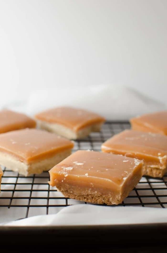 Spiced Ginger Millionaires Shortbread Cookie Bars - Fondly known as Spiced Ginger Twix Bars! soft crumbly shortbread base with a soft melt in your mouth, vanilla caramel and coated with semi sweet chocolate! The next best thing since the Twix Bar!