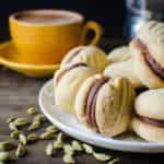 Cardamom and Orange Melting Moments Cookies with Chocolate Truffle filling - Incredibly delicious cookies that melt in your mouth! It's like the shortbread cookie's more delicate, crisper cousin. So easy to make and it will disappear in seconds!