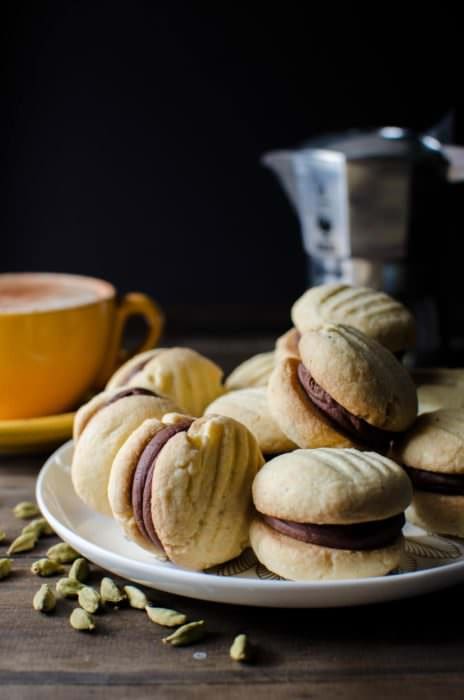 Cardamom and Orange Melting Moments Cookies with Chocolate Truffle filling - Incredibly delicious cookies that melt in your mouth! It's like the shortbread cookie's more delicate, crisper cousin. So easy to make and it will disappear in seconds!