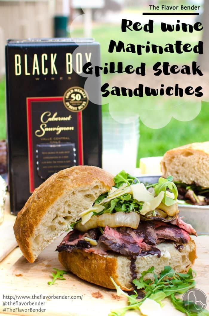 [Msg 4 21+] Red Wine marinated Grilled Steak Sandwich with a Red wine Glaze, Grilled Onions, Arugula and Aged Cheddar. Red wine marinated, succulent, perfectly grilled steak, sliced and piled on toasted bread topped with a buttery red wine glaze! A Perfect Picnic Sandwich! REPIN to save. CLICK to get the recipe now. #TheFlavorBender #BlackBoxSummer [ad]