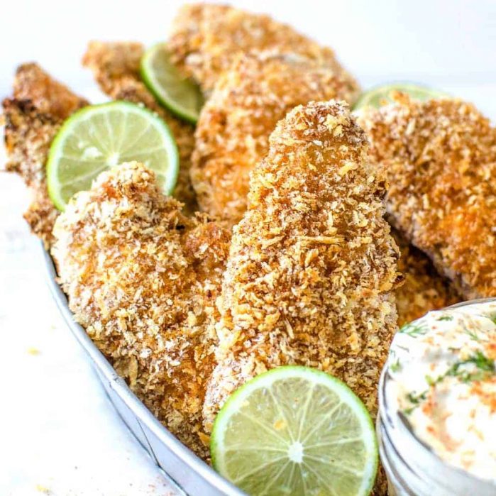 Taco Spiced Crispy Baked Chicken Tenders -  are absolutely THE BEST baked, crunchy chicken tenders, with a crispy and flavorful twist with a golden panko bread crumb coating and a taco spiced seasoning. Perfect with a Herb and lime Sour Cream dip! CLICK to get recipe. REPIN for later! #TheFlavorBender