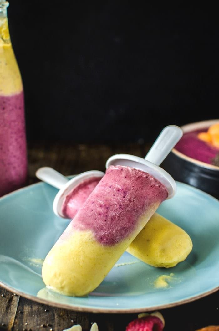 Frozen Date, Peanut Butter Berry Smoothie popsicles with Mango Peanut Butter smoothie - a Secret ingredient that makes this taste AMAZING will have you hooked to this protein packed delicious smoothie snack! Perfect as a healthy smoothie bowl, or as an On the Go layered smoothie (included in recipe)! This is #MySmoothie REPIN to save. CLICK to get the recipe! #TheFlavorBender