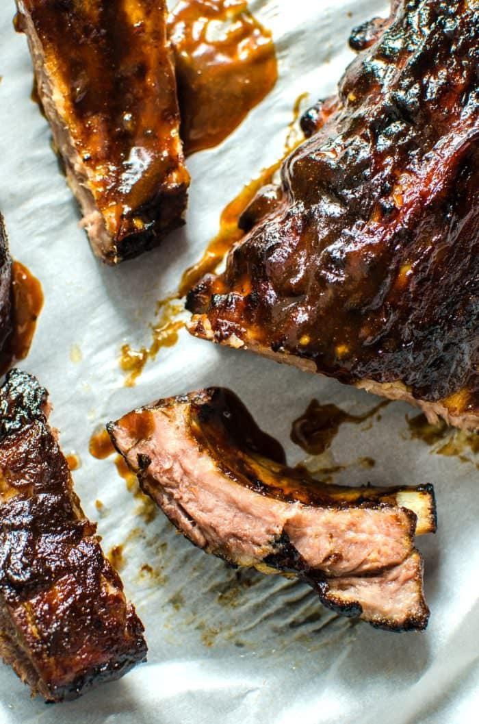 Habenero and Peach BBQ Pork Ribs - Marinated with a sweet and spicy habanero peach BBQ sauce, these pork baby back ribs can be cooked completely in the oven, or finished off on the grill for a glorious smoky flavour. This is a foolproof recipe that results in deliciously juicy meat with a rich, dark brown crust on top, that pulls off the bone cleanly. SAVE to repin. CLICK to get the recipe. #MyKCMasterpiece [ad] #TheFlavorBender