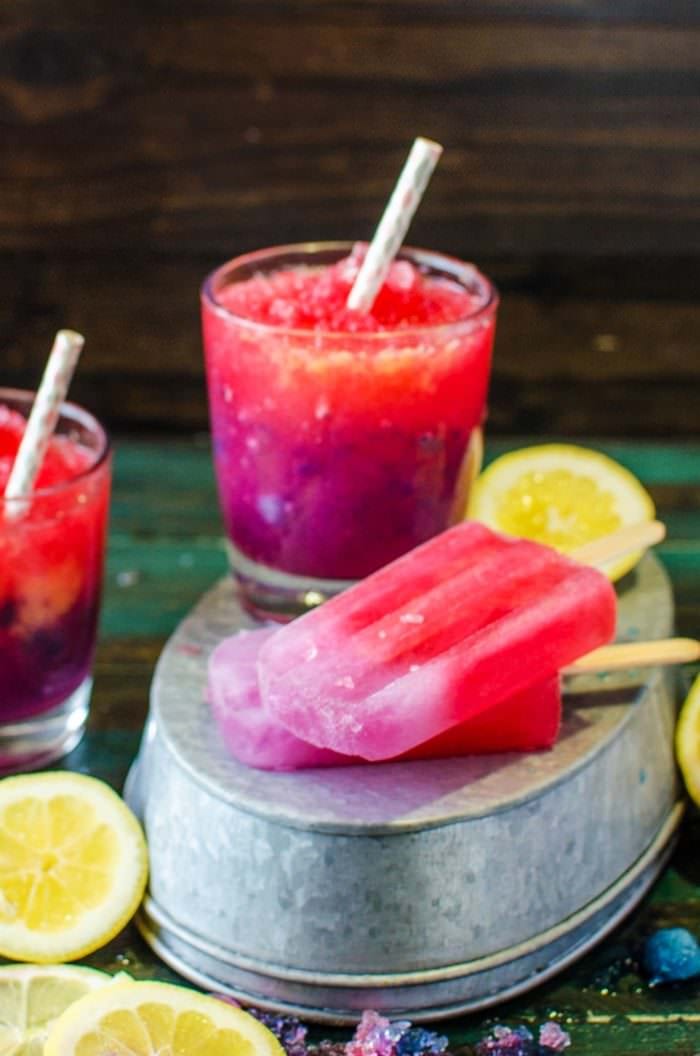 Color Changing Purple and Pink Lemonade Slushies & Popsicles - These kid friendly treats are as magical as they are delicious! You kids will absolutely LOVE these! Have fun with your food while you cool down this summer with these beautiful naturally colored, homemade, color changing lemonade slushies!