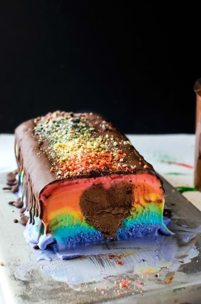 Surprise Inside Rainbow Ice Cream Slice - A deliciously creamy rainbow ice cream slice in bright rainbow colors with a rich, creamy, heart-shaped chocolate mousse center! A fabulous no bake Summer dessert to share with all the people that we love in our lives. SAVE to repin. CLICK to get RECIPE + VIDEO