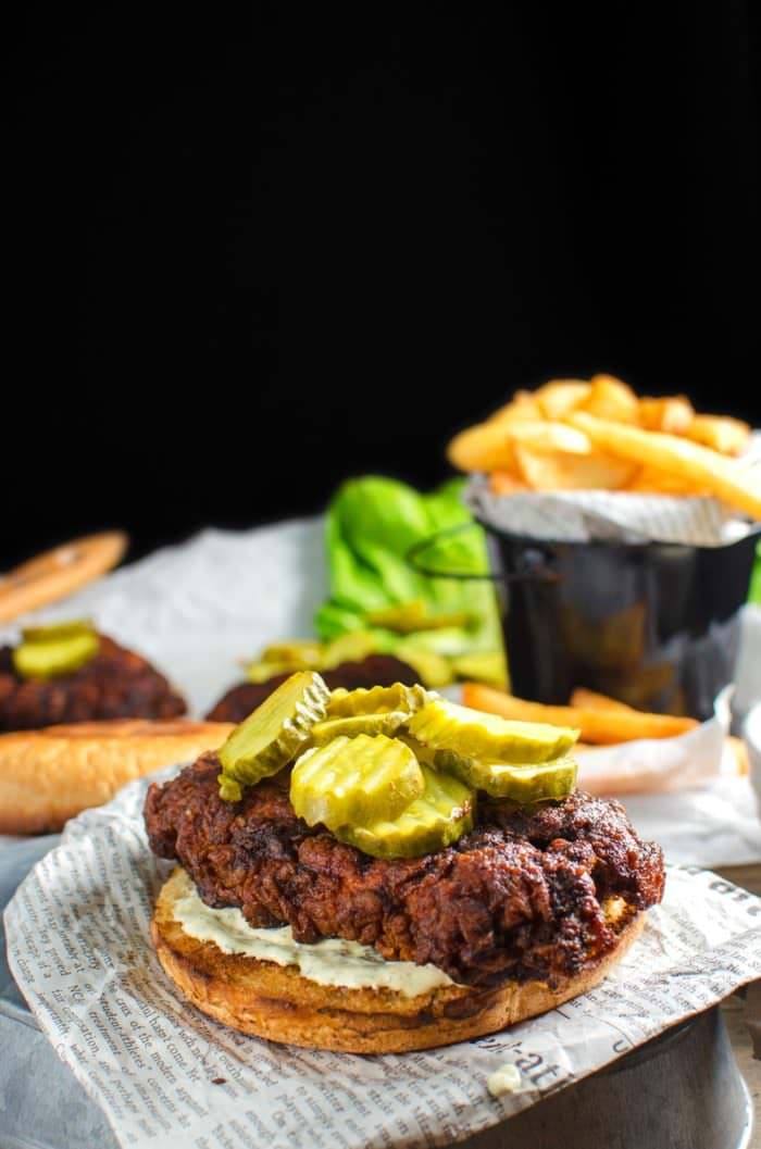 Nashville style Hot and Spicy Fried Chicken Sandwich - Flavored with a sizzling hot sauce and spice blend that penetrate the crispy coating, and then paired with a cool, herby, tangy sour cream ranch dressing. Get the recipe from #TheFlavorBender
