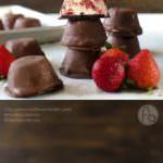 Frozen Jalapeno Strawberry Cheesecake Bites - A rich, creamy cheesecake center, swirled with fresh strawberries and a delectable strawberry jalapeno spread, with an oreo cookie base and then covered in a chocolate shell - these Frozen Strawberry Cheesecake Bites are an easy, addictive snack, perfect for summer and for parties! (SAVE to repin, CLICK to get the recipe!)