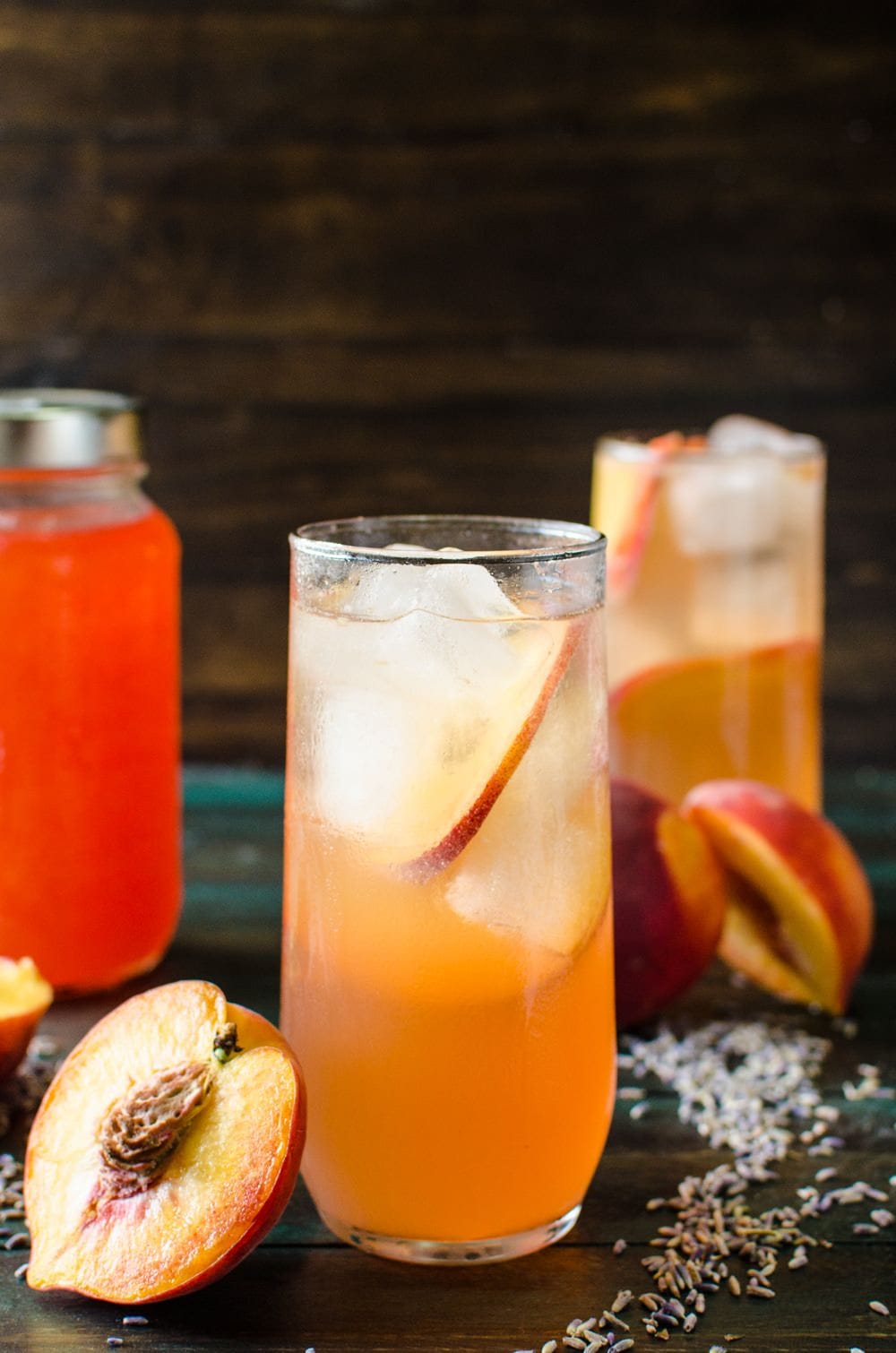Lavender Peach Shrub Syrup - This sweet, fruity, tangy, floral Lavender Peach Shrub Syrup is simple to make and is a great way to use up bruised, overripe peaches. Mix with ice cold water for a refreshing, non-alcoholic summer drink, or with some vodka or tequila for a delicious cocktail, or with some champagne for a wonderful mimosa!