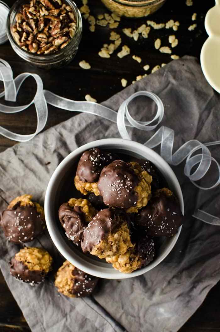 Chocolate dipped No bake Pecan Pie Cookies with Rice Krispies - pack all the nutty deliciousness of your fall-favorite pecan pies! Plus they make excellent gifts for the holidays too. Dairy-free friendly and vegan-friendly.