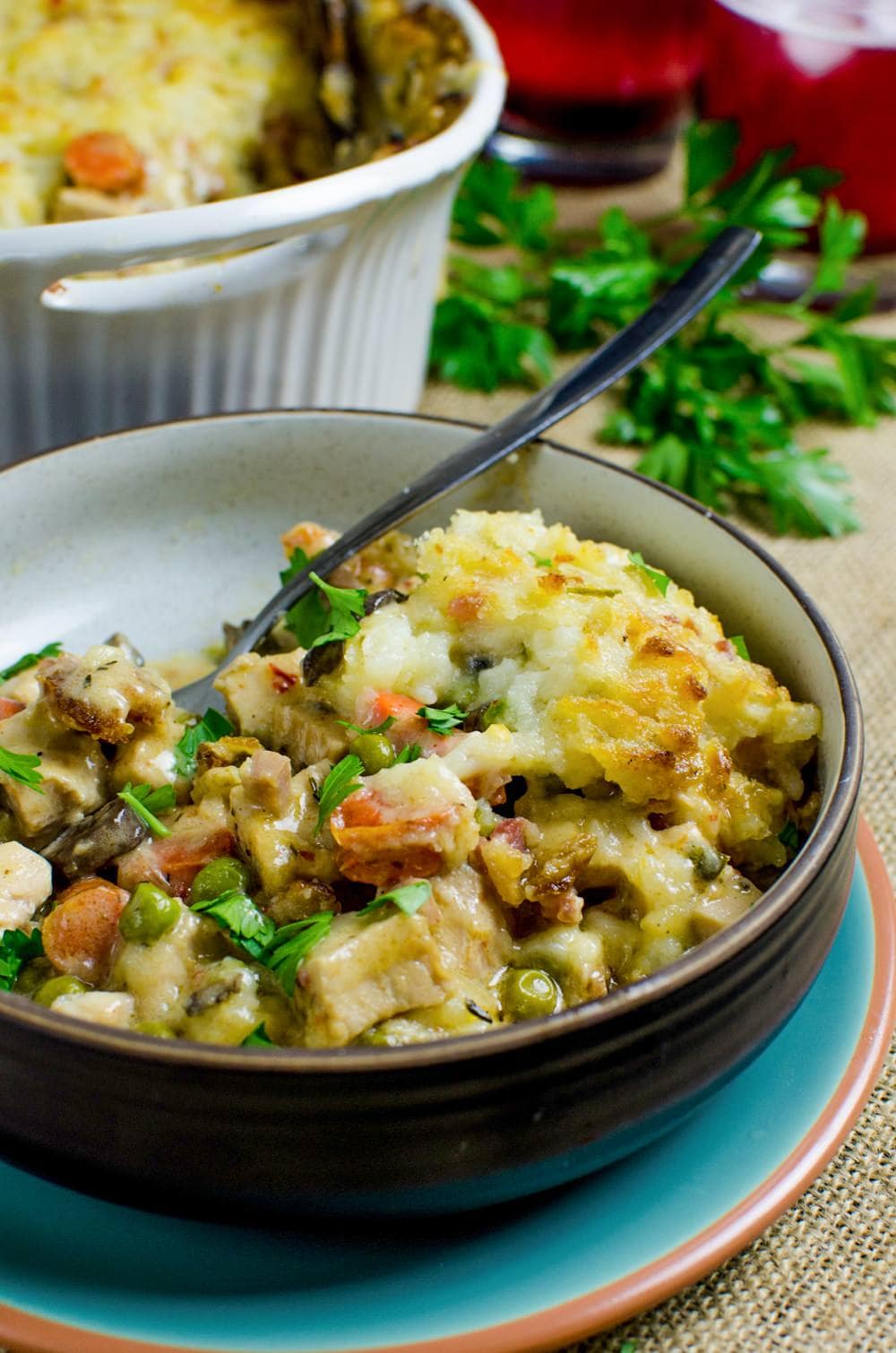 This Creamy Turkey Shepherd's Pot Pie topped with cheese, bacon and creamy mashed potato, and then baked until the potatoes turn a light golden brown, will have you counting down the days for the day after thanksgiving!