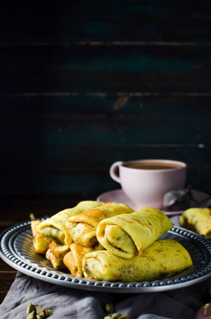 Sweet Coconut stuffed Crepes - Sri Lankan Pani Pol - Soft turmeric crepes, filled with a spiced sweet coconut filling. A Sri Lankan classic sweet snack loved by kids and adults. Perfect for tea time, parties, or simple dessert! A wonderfully, unique and delicious sweet treat that you will love!