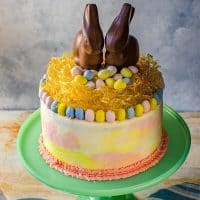 Chai and Vanilla Cake with soft, fluffy Vanilla Buttercream frosting - A spectacular swirled Easter cake with a gorgeous pastel watercolor effect, decorated with Easter eggs, chocolate bunnies and a caramelized nest on top! A sunny, happy and outrageously delicious cake to celebrate all of life's special occasions and nostalgic memories!
