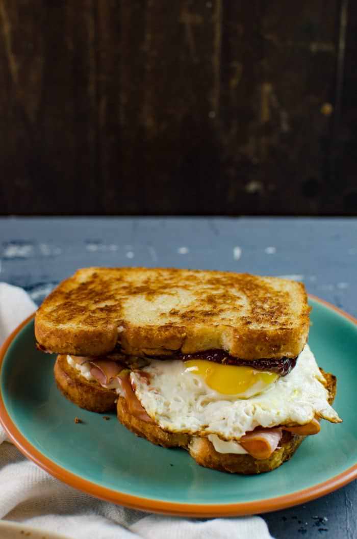 Raspberry, Ham and Egg sandwich - This is the definition of a happy sandwich! Creamy with a touch of sweetness, fruity freshness and an egg cooked right into a slice of toast. A twist on a Monte Cristo Sandwich with just 6 ingredients.