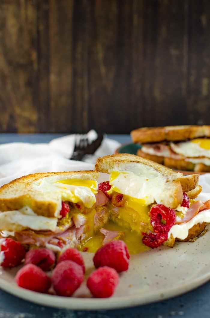 Raspberry, Ham and Egg sandwich - This is the definition of a happy sandwich! Creamy with a touch of sweetness, fruity freshness and an egg cooked right into a slice of toast. A twist on a Monte Cristo Sandwich with just 6 ingredients.