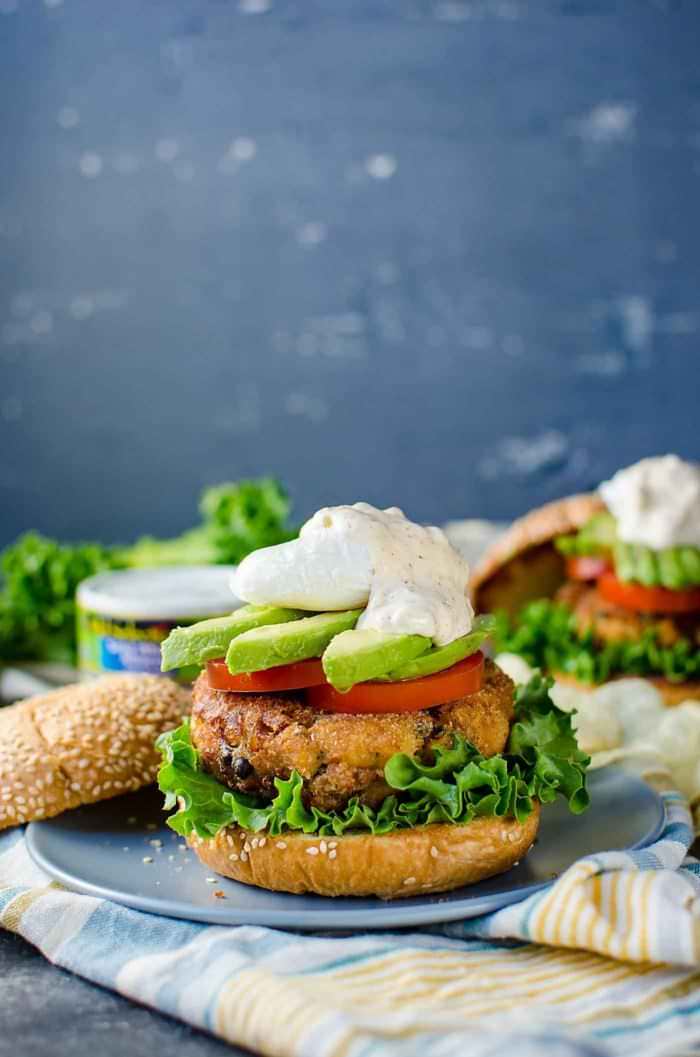 Crispy Tuna Burger with Lemon and Capers - A delicious burger topped with a spiced aioli tartar sauce, tomatoes, avocado and an egg. Transform your canned tuna into a scrumptious brunch burger or spectacular dinner with just a few easy steps.