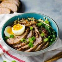 Easy Pork Ramen - Thinly sliced, perfectly cooked, juicy pork tenderloin and an egg with a gloriously runny egg yolk, crunchy Asian greens, and flavorful mushrooms, all swimming in a scrumptious and flavor-packed ramen noodle broth. All in less than 30 minutes! 