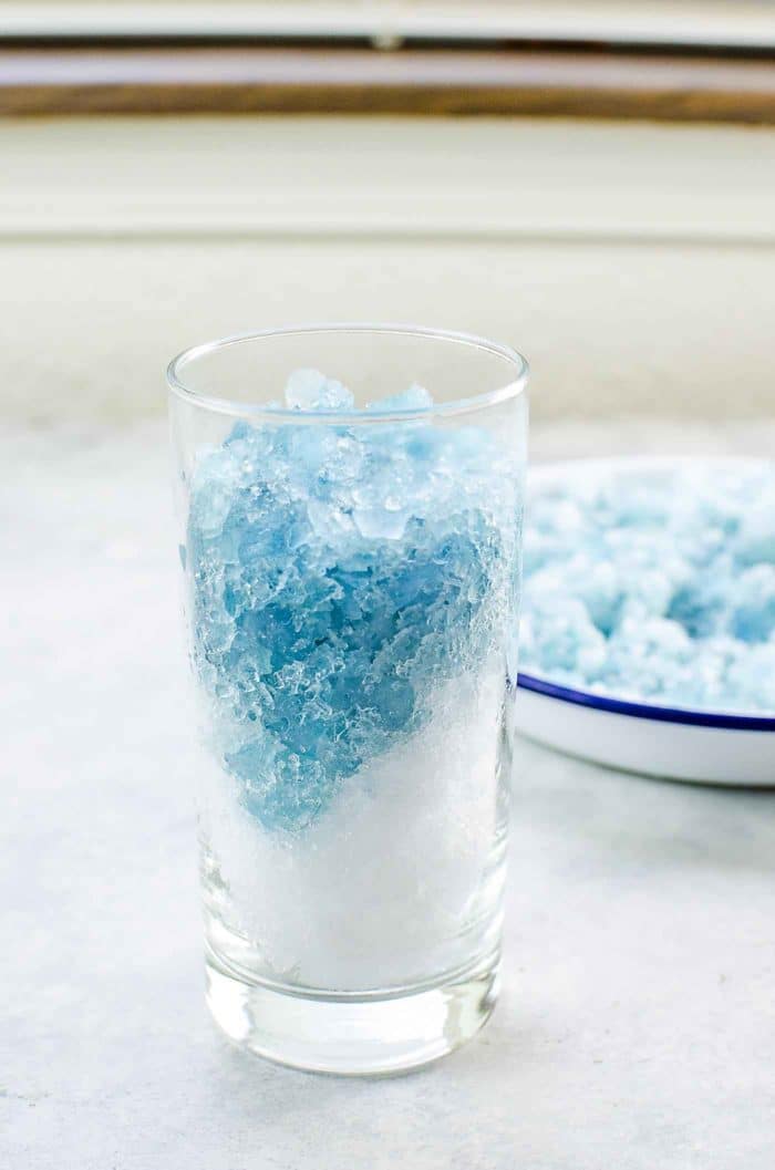 Color Changing Galaxy Lemonade Slushie - There's no food coloring in this Color Changing Lemonade Slushie - Layer the regular and magic ice in the glass