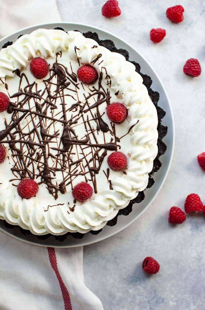 Popping No Bake Chocolate Raspberry Pie - An irresistibly creamy, smooth, and fool-proof dessert with  a decadent chocolate pudding filling, with fresh raspberries and a pop rock cookie crust!