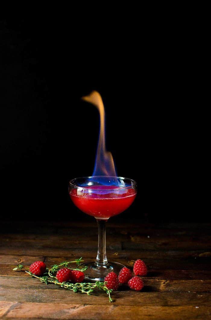 Flaming Dragon's Blood Cocktail - Thyme and Raspberry Daiquiri for parties. A showstopping flaming Halloween Cocktail made with raspberries and thyme. 