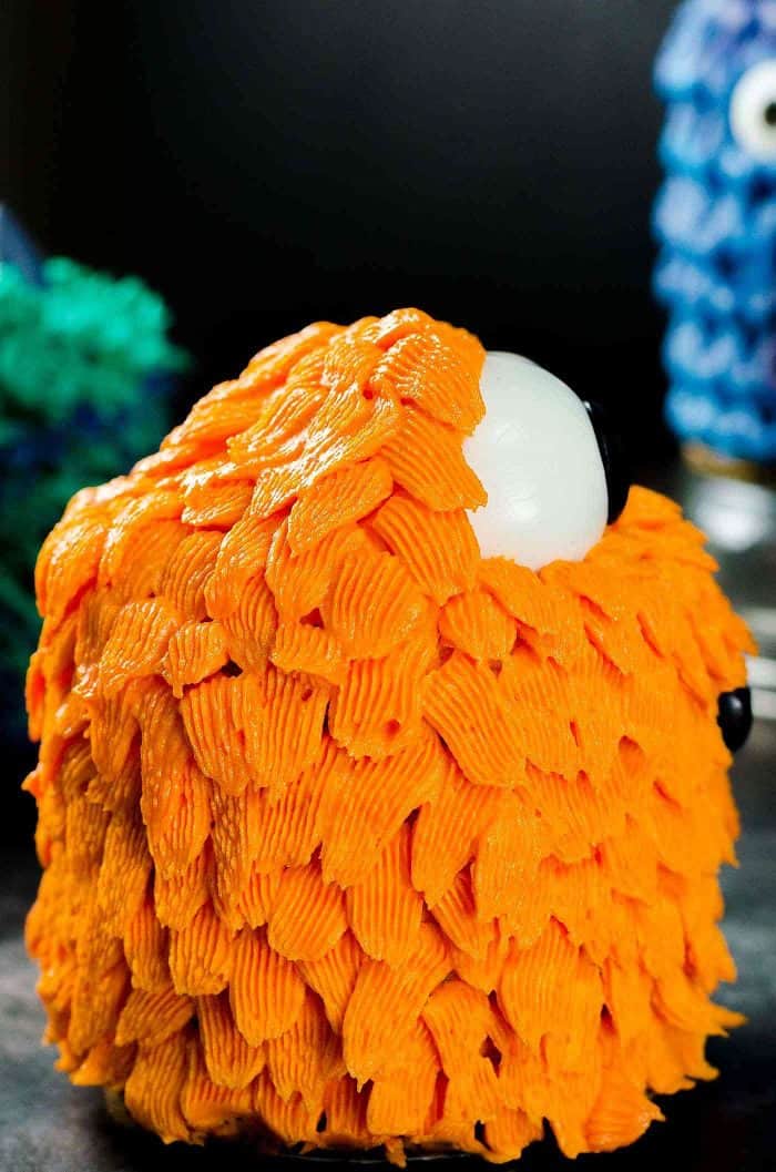 Orange Pet monster - The basket weave fur give a raggedy look that I love. Side view of the cake shows the direction of the piped fur.