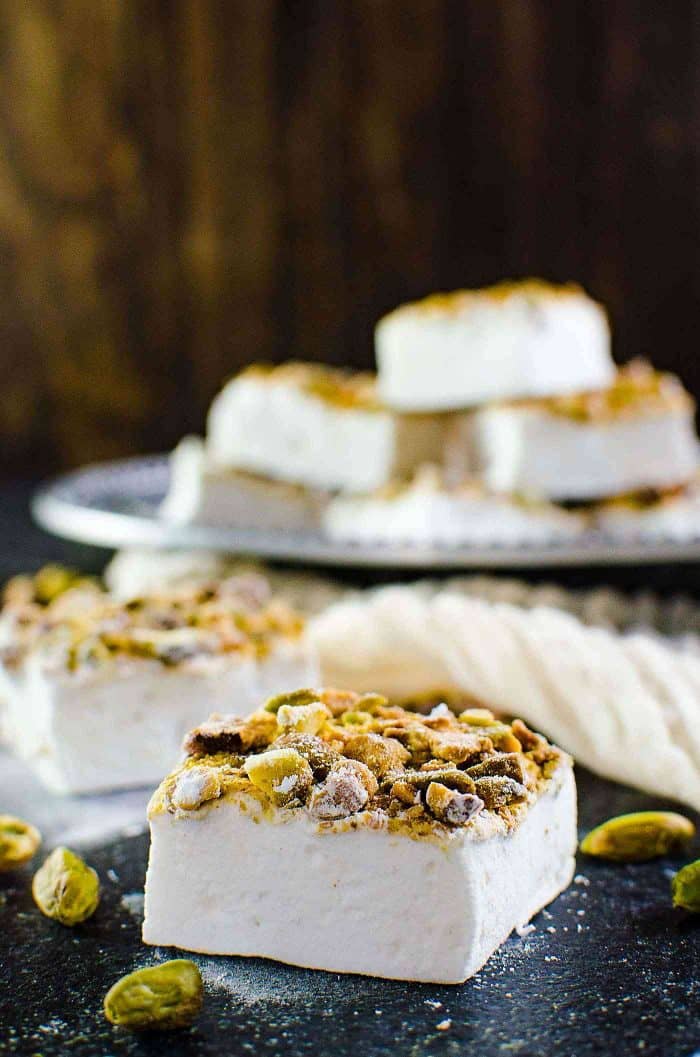 Orange blossom Marshmallows with Pistachios - (Orange blossom pistachio marshmallows) Fluffy, melt in your mouth homemade Marshmallows made with no corn syrup and so easy to make too! Flavored with exotic orange blossom water and roasted pistachios, these are perfect for gift giving for Christmas or any holiday. 