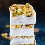 Stack of homemade orange blossom marshmallows with roasted pistachio topping.