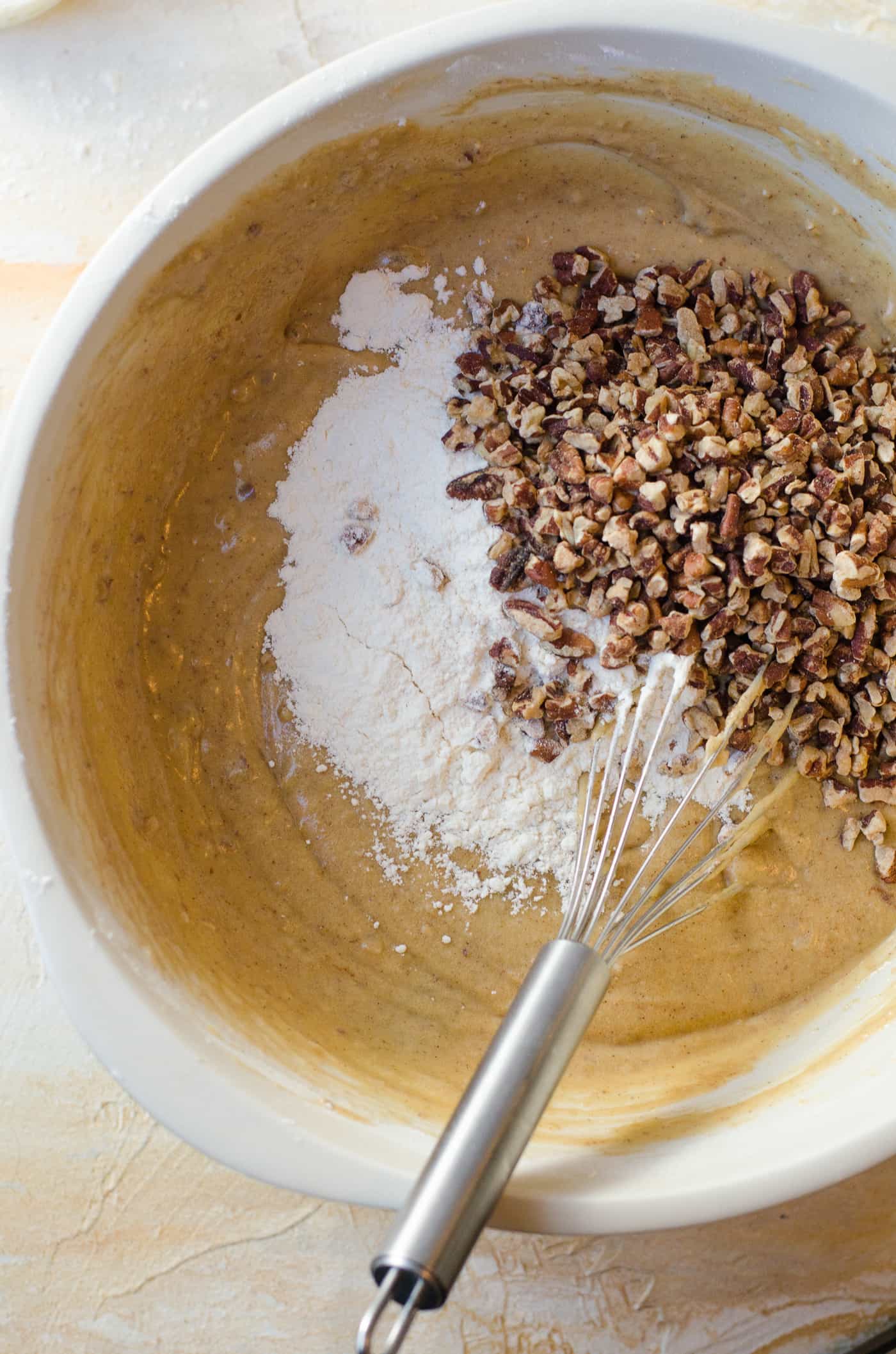 Spiced Bourbon Butter Pecan Cake with Brown Butter Maple Frosting - Adding the flour and chopped pecans