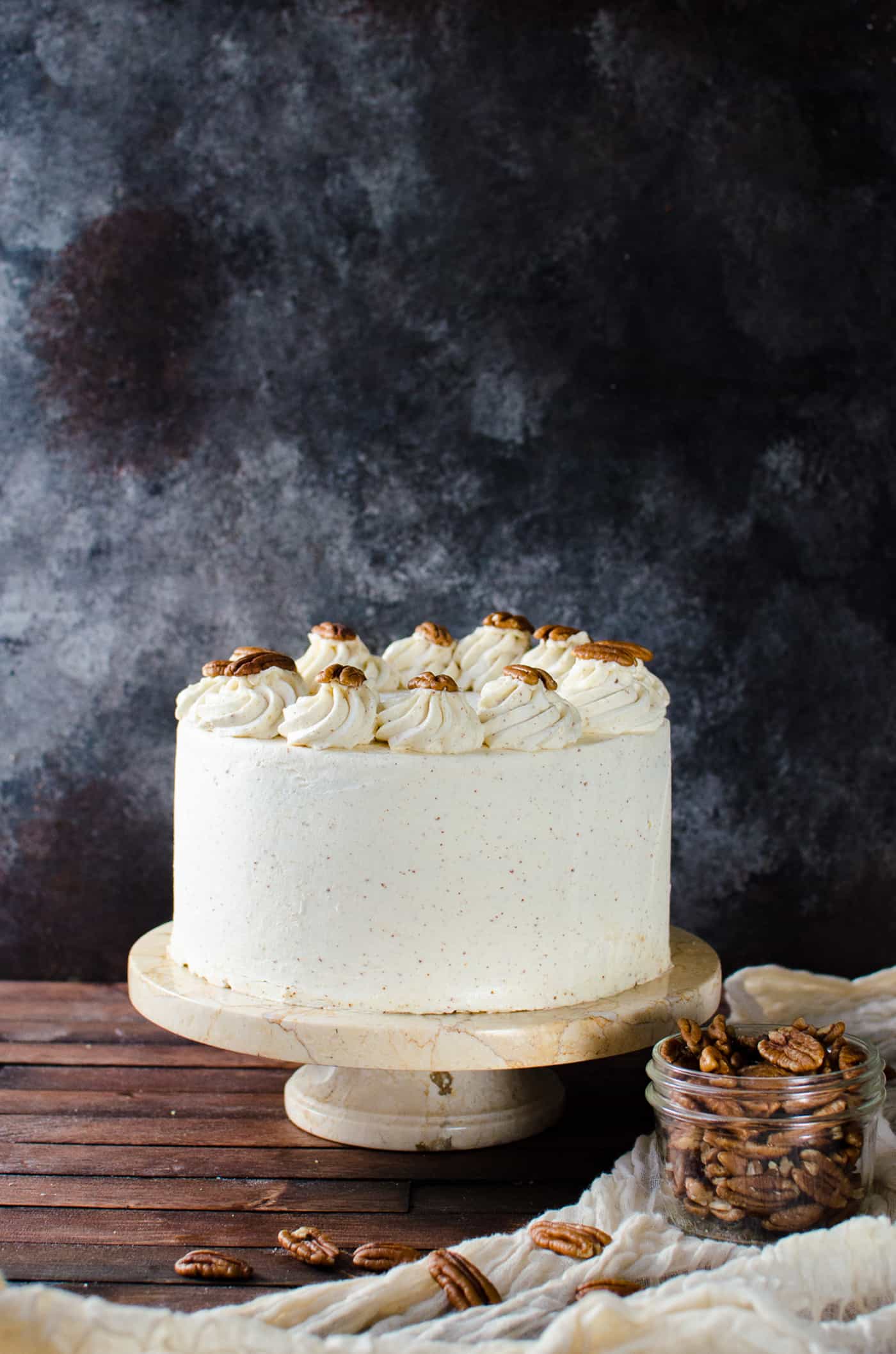 Spiced Bourbon Butter Pecan Cake with Brown Butter Maple Frosting - A fall cake that's perfect for thanksgiving dessert.  Flavors of a pecan pie in a cake with nutty, sweet and spiced flavors. 