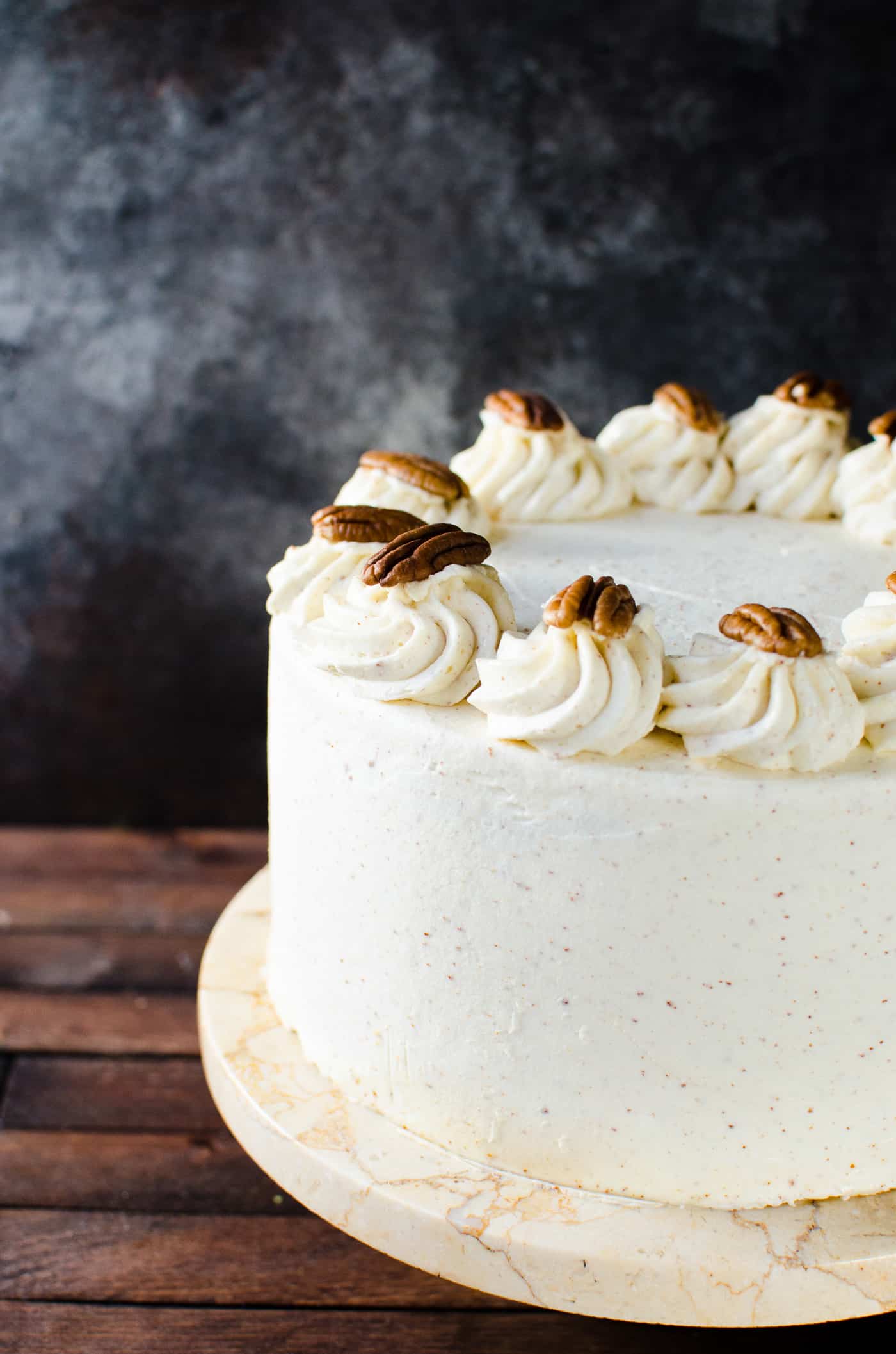 Spiced Bourbon Butter Pecan Cake with Brown Butter Maple Frosting - A fall cake that's perfect for thanksgiving dessert.  Flavors of a pecan pie in a cake with nutty, sweet and spiced flavors. 