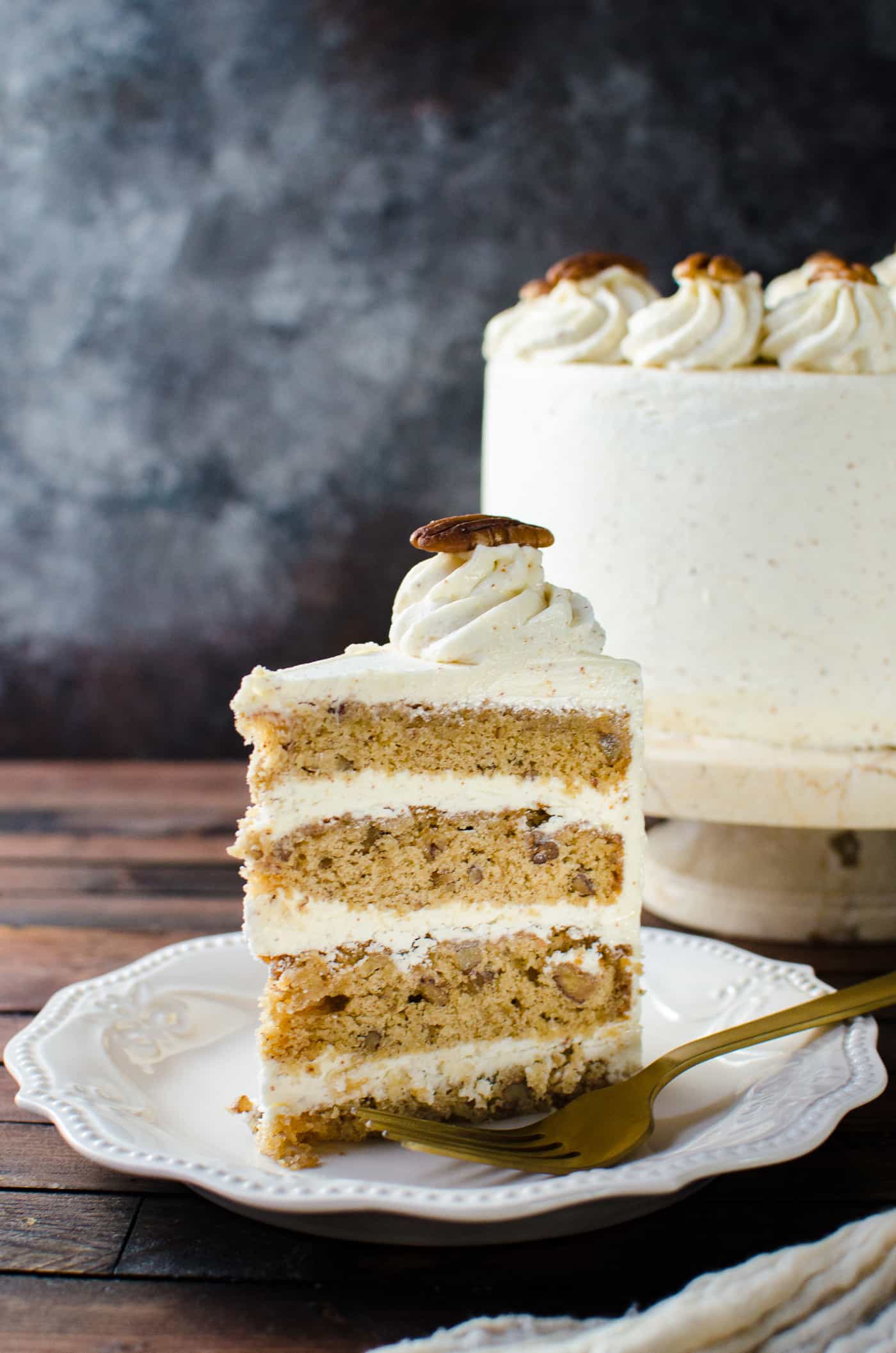 Spiced Bourbon Butter Pecan Cake with Brown Butter Maple Frosting - A fall cake that's perfect for thanksgiving dessert.  Flavors of a pecan pie in a cake with nutty, sweet and spiced flavors. 