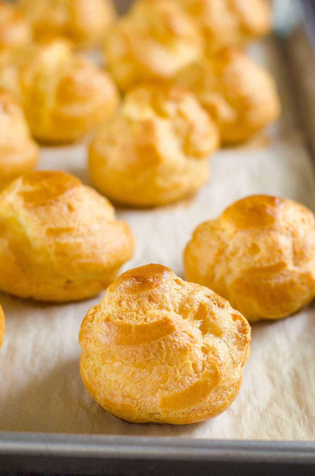Puffed up and golden brown choux pastry, ready to be used for cream puffs