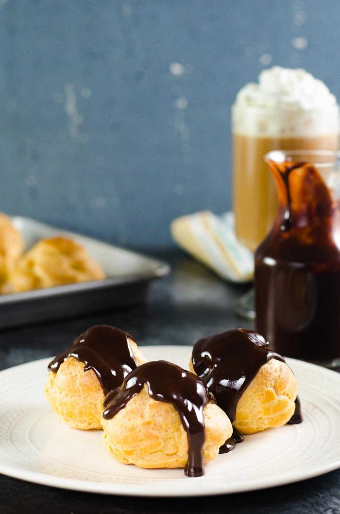 Chocolate Profiteroles with Pastry Cream (Cream Puffs) - rich, creamy custard filling inside light, airy, crispy, perfectly baked choux pastry shells, and then drizzled with a luscious chocolate sauce on top.
