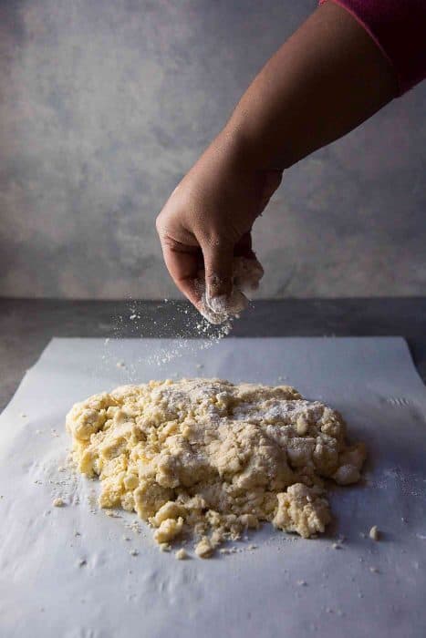 Cream Scones - The dough doesn't come together and looks clumpy or shaggy. Use floured hands to bring the dough together.