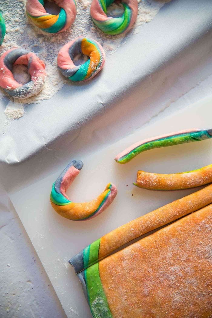 Mini rainbow donuts - Cut strips and shape them into donuts with the bagel method. You can twist them or keep the colors straight. 