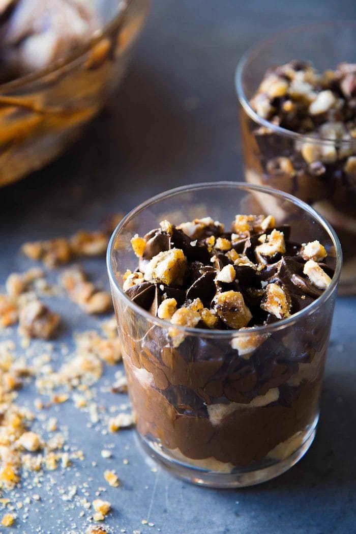 Chocolate Hazelnut Trifle - Layers of silky smooth hazelnut liqueur flavored chocolate mousse, and hazelnut liqueur soaked ladyfingers, topped with crunchy hazelnut praline and whipped cream
