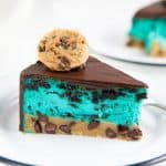 Slice of cookie monster cheesecake showing blue cheesecake layer and chocolate chip cookie blondie base.