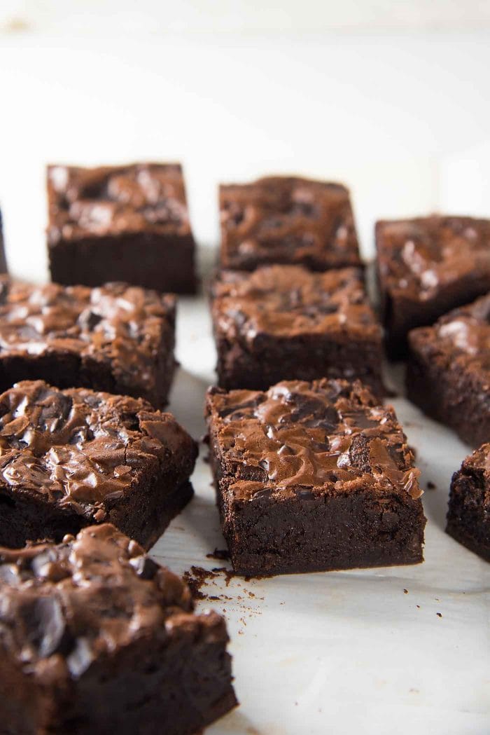 Freshly baked brownies on a parchment paper. 