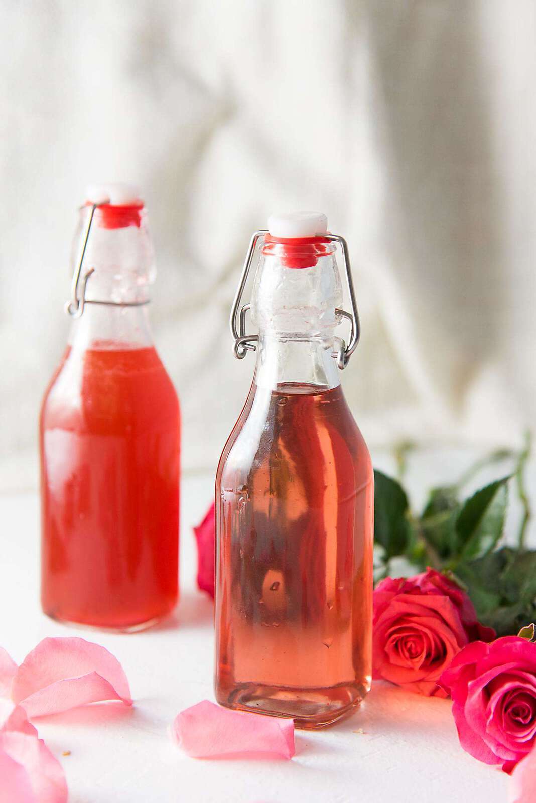 Learn how to make Rose syrup. Perfect for cocktails and other drinks. Made with rose water and can be naturally colored or colored with food coloring. 