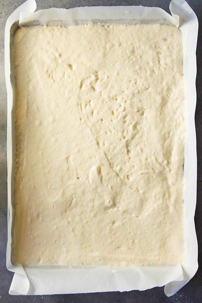 Spread out the buttermilk pancake batter in the prepared sheet pan as evenly as possible.