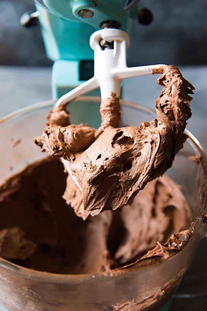 After whisking the creamy chocolate buttercream, you can use a paddle attachment to remove some of the air from the buttercream, to make it smoother.