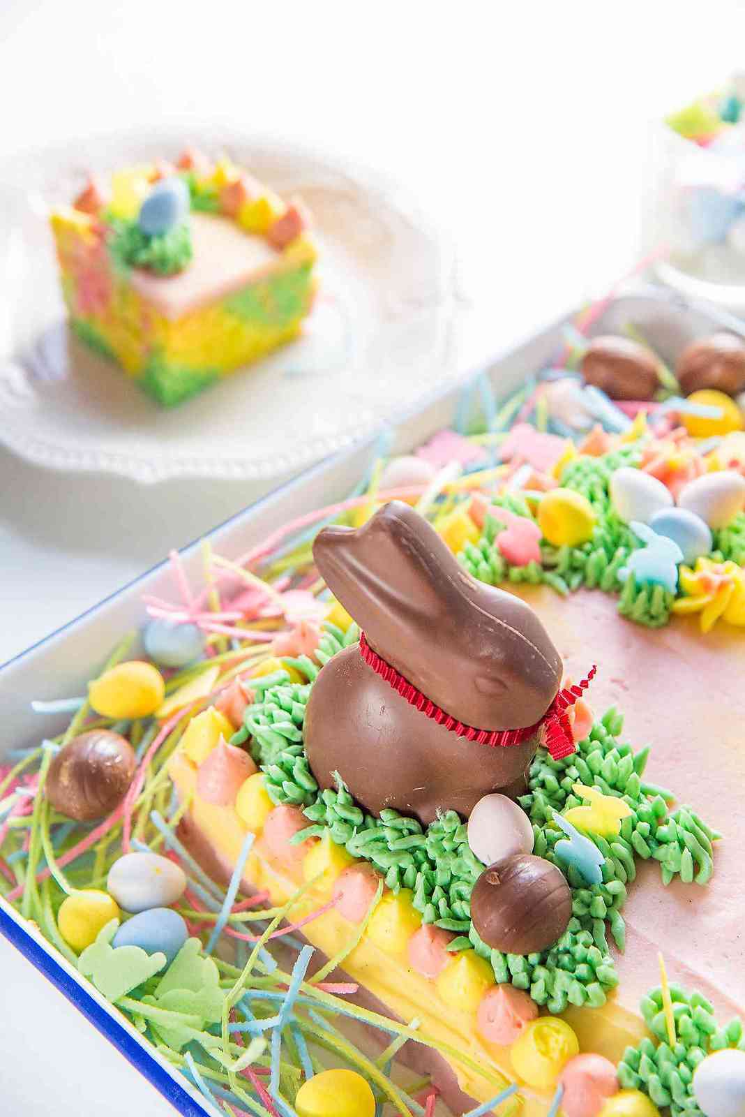 Pastel Easter Cake - This gorgeous Easter sheet cake is a cinch to decorate with buttercream decorations and your favourite Easter candy! It's perfect for a crowd and is the best butter and soft vanilla cake!