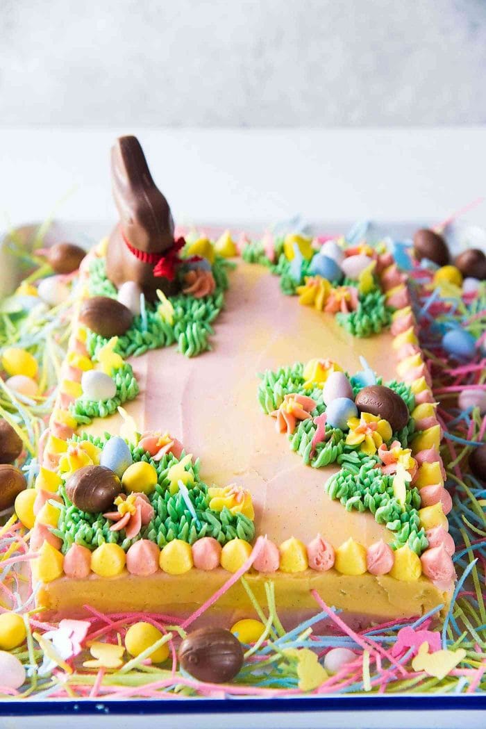 Pastel Easter Cake - This gorgeous Easter sheet cake is a cinch to decorate with buttercream decorations and your favourite Easter candy! It's perfect for a crowd and is the best butter and soft vanilla cake!