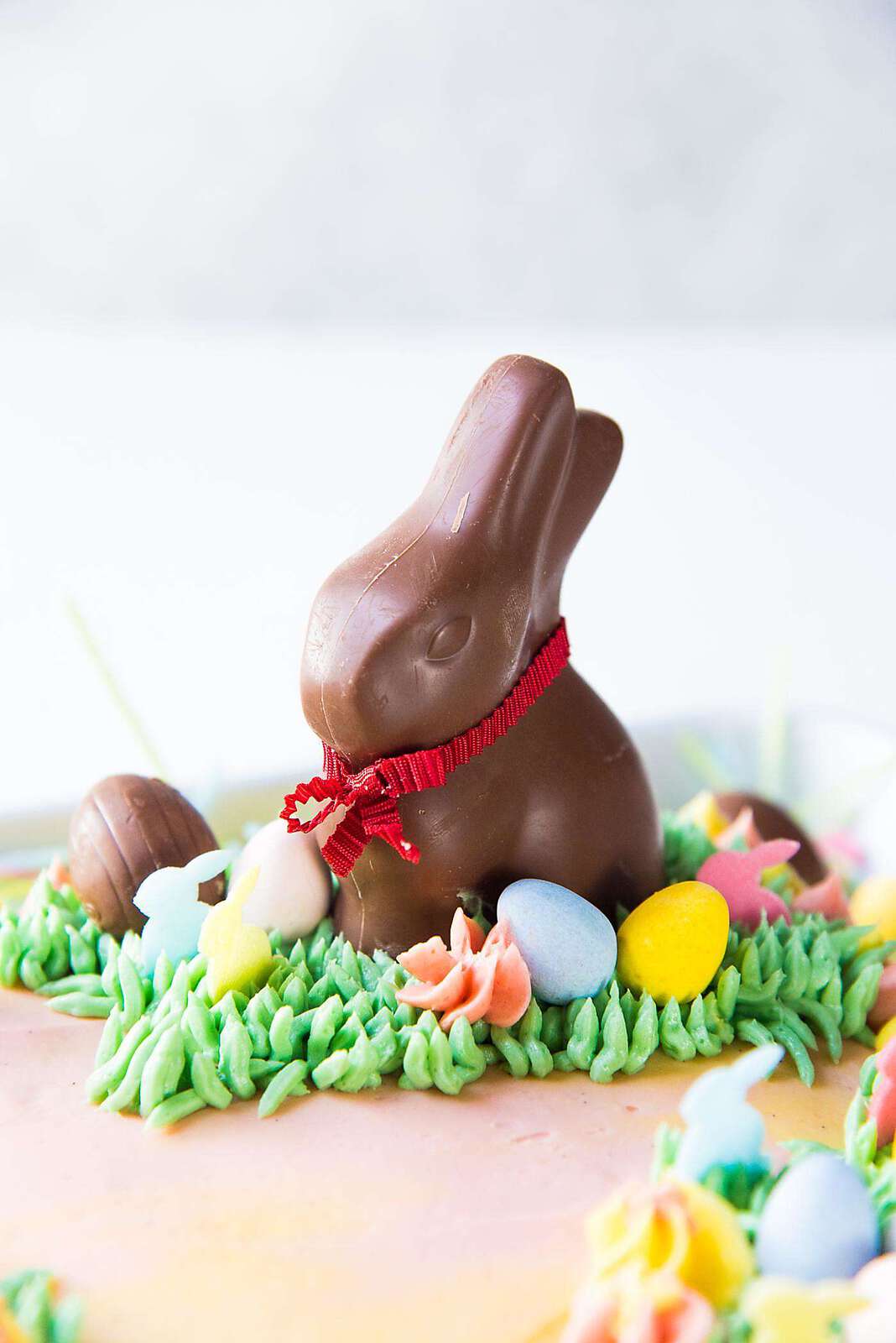 Pastel Easter Cake - Decorate the cake with green buttercream grass, Easter eggs and chocolate bunnies to make it perfect for Easter celebrations!