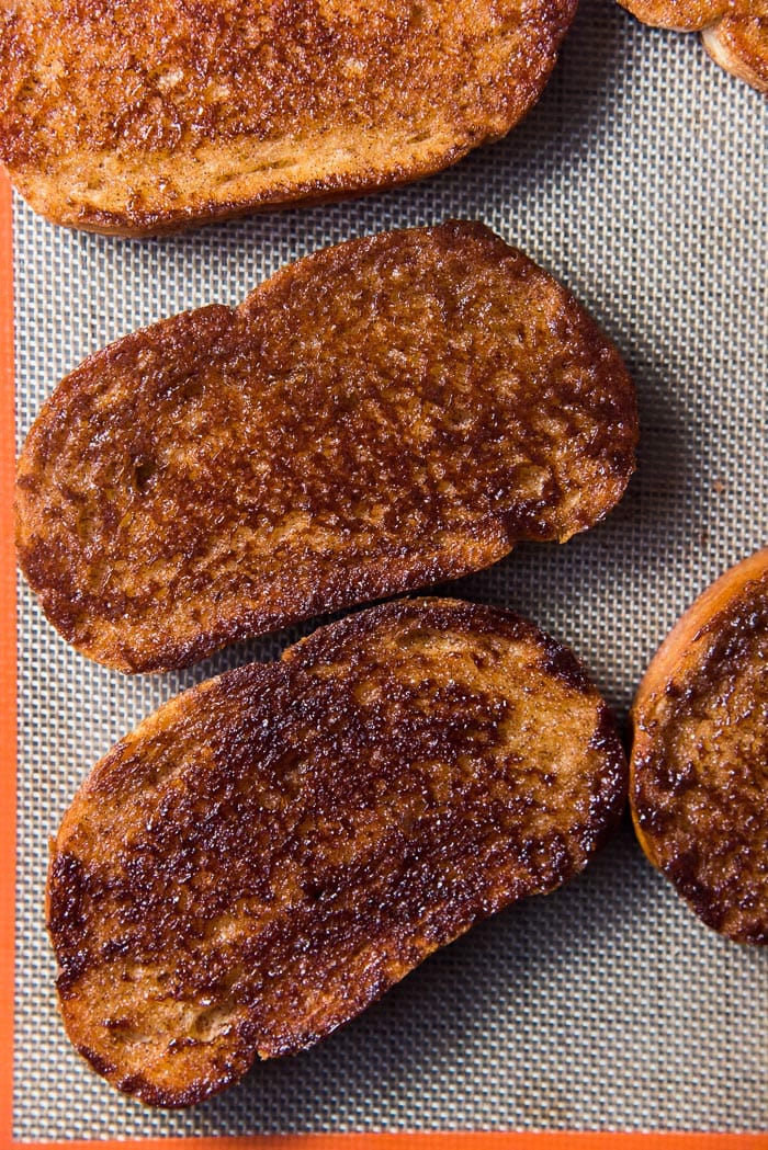 An overhead image of slices of caramelized cinnamon toasts, on a silpat.