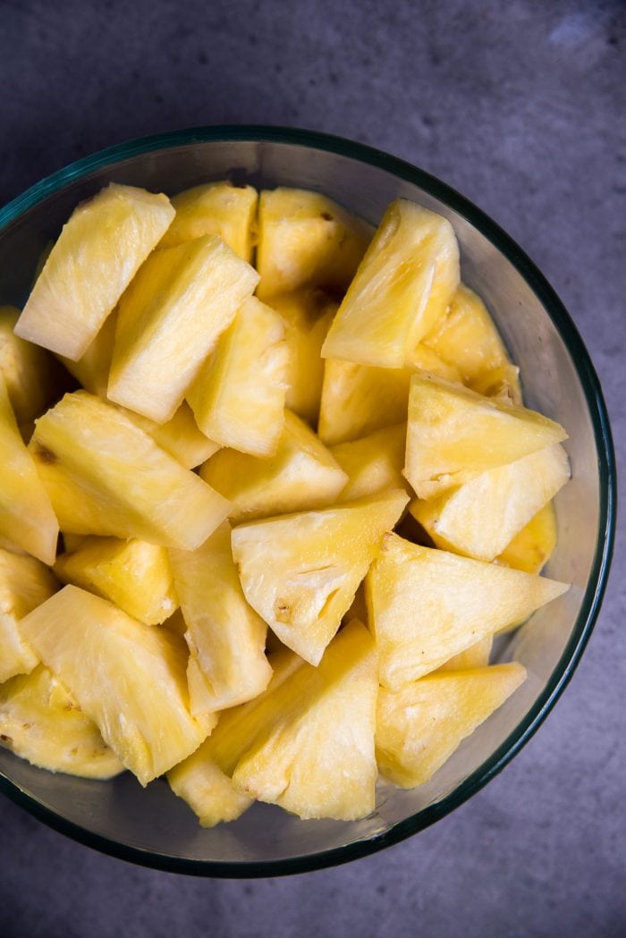 Freshly cut pineapple in a bowl to make pineapple juice. The amount of sugar added depends entirely on the sweetness of the drink. 